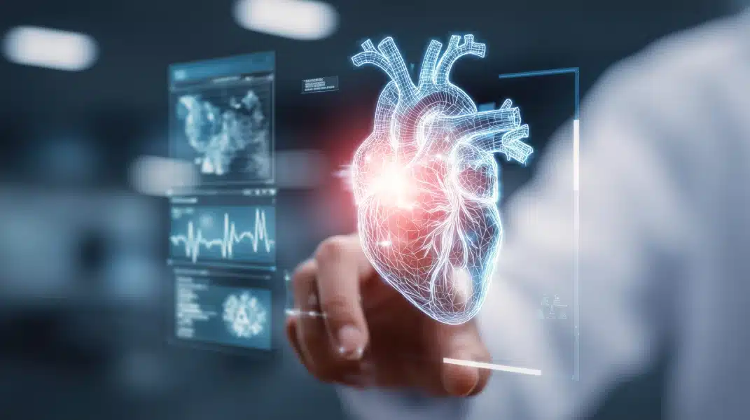 Doctor touching a glowing 3D wireframe digital heart hologram